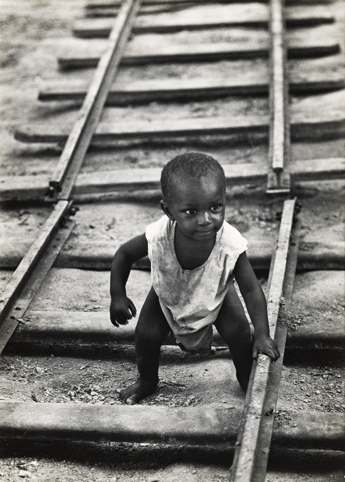 W. EUGENE SMITH (1918-1978) Baby boy on railroad track, from A Man of Mercy.